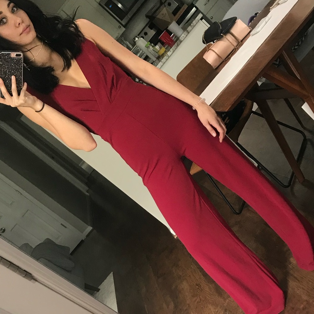 red flared v-neck jump suit, open lace back